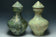 TWO LARGE HAN DYNASTY GREEN GLAZED HU VASES AND COVERS