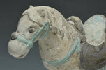 A CHINESE MING DYNASTY PAINTED POTTERY HORSE