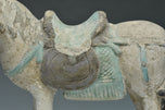 A CHINESE MING DYNASTY PAINTED POTTERY HORSE