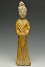 A TANG DYNASTY AMBER GLAZED FIGURE OF A COURT LADY
