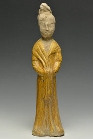 A TANG DYNASTY AMBER GLAZED FIGURE OF A COURT LADY