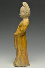 A TANG DYNASTY AMBER GLAZED FIGURE OF A COURT LADY