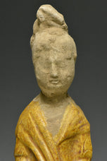 A TANG DYNASTY AMBER GLAZED FIGURE OF A COURT LADY