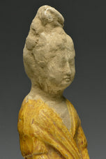 A TANG DYNASTY AMBER GLAZED FIGURE OF A COURT LADY