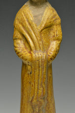 A TANG DYNASTY AMBER GLAZED FIGURE OF A COURT LADY