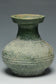A HAN DYNASTY GREEN GLAZED HU SHAPED VASE