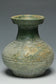 A HAN DYNASTY GREEN GLAZED HU SHAPED VASE