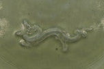 A LARGE YUAN DYNASTY LONGQUAN CELADON DRAGON DISH