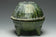 A HAN DYNASTY GREEN GLAZED DING AND COVER