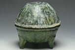 A HAN DYNASTY GREEN GLAZED DING AND COVER