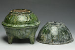 A HAN DYNASTY GREEN GLAZED DING AND COVER