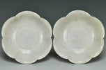 A PAIR OF SONG DYNASTY CARVED QINGBAI FOLIATE-RIM DISHES