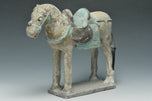 A MING DYNASTY PAINTED POTTERY HORSE