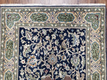1950S SEMI ANTIQUE PERSIAN QUM TREE OF LIFE RUG, HAND-KNOTTED, WOOL, MIDNIGHT BLUE AND TAN, ANIMAL PICTORIALS, WRITTEN POEM IN BORDERS, 4' 8" X 7' 8"