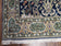 1950S SEMI ANTIQUE PERSIAN QUM TREE OF LIFE RUG, HAND-KNOTTED, WOOL, MIDNIGHT BLUE AND TAN, ANIMAL PICTORIALS, WRITTEN POEM IN BORDERS, 4' 8" X 7' 8"