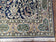 1950S SEMI ANTIQUE PERSIAN QUM TREE OF LIFE RUG, HAND-KNOTTED, WOOL, MIDNIGHT BLUE AND TAN, ANIMAL PICTORIALS, WRITTEN POEM IN BORDERS, 4' 8" X 7' 8"